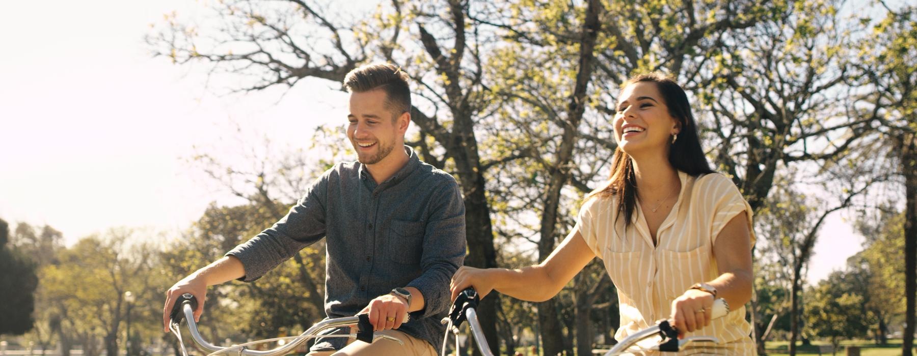 a man and woman riding bikes