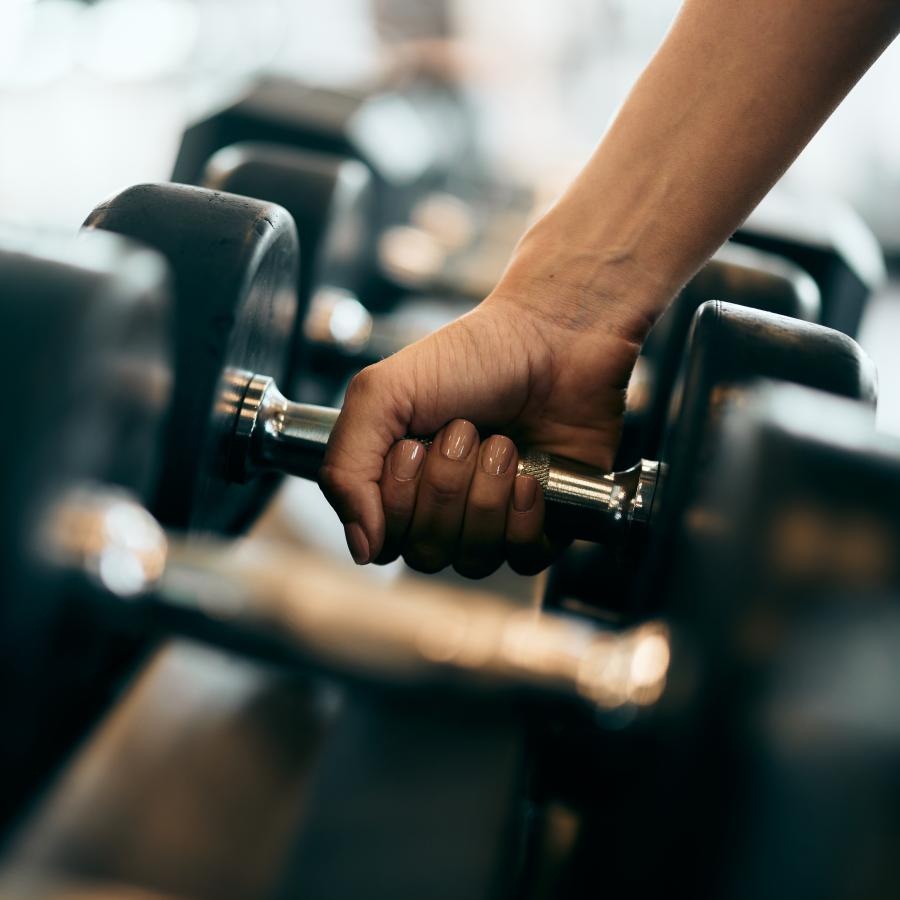 a person picking up a dumbell